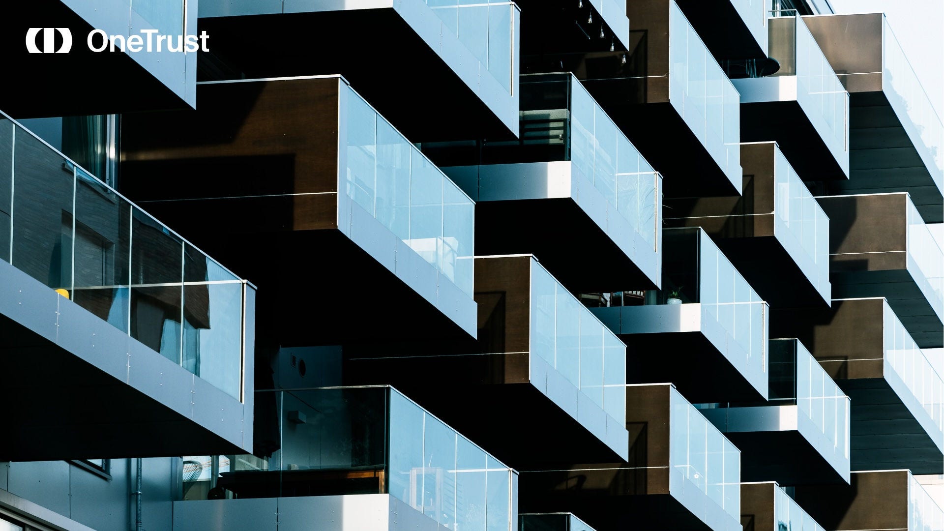 OneTrust logo over a photo of modern glass balconies on a multi-story building exterior